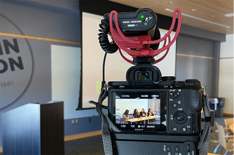 Image of Tyler filming a panel