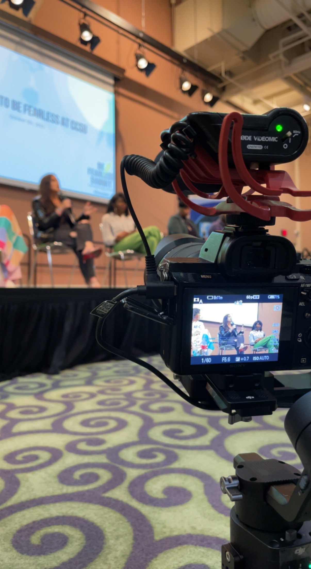 Image of Tyler filming a panel