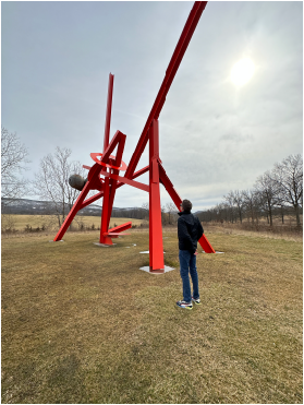 Image of Tyler looking at sculpture